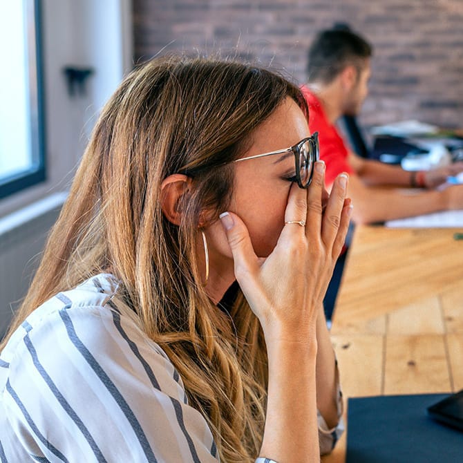 Mujer frotándose los ojos cansados